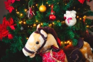 47200968_christmas-tree-with-bauble-decorations-and-fairy-lights-with-a-toy-rocking-horse-in-front